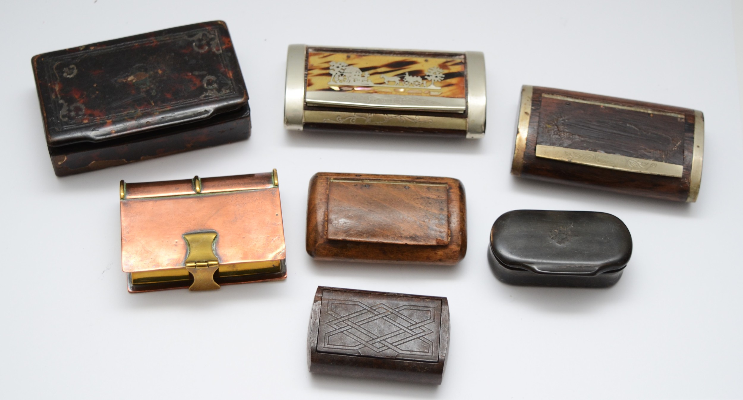 A collection of late 19th century and later snuff boxes, to include a brass and copper example in