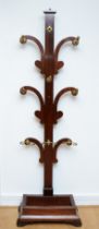 A Victorian mahogany hall coat stand, the central upright issuing three tiers of scroll shaped