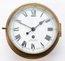 A 20th century ships brass bulkhead clock, having 8-day movement with enamelled dial, roman and