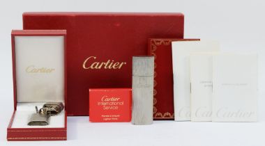 Cartier, a brushed stainless steel and gold screw gas lighter, numbered E 72746, dismantled, case,