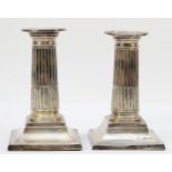 A Victorian silver pair of short Corinthian column candlesticks, Sheffield 1898, with pull off