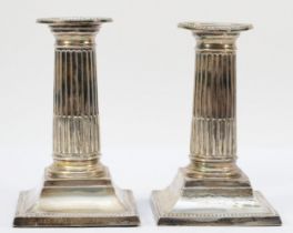 A Victorian silver pair of short Corinthian column candlesticks, Sheffield 1898, with pull off