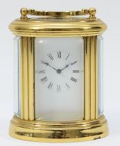 A miniature brass case carriage clock, circa 20th century, of oval form having a French 8 day