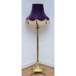 A late 20th century brass standard lamp with fabric shade, in the form of a Corinthian