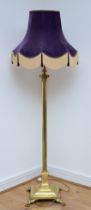 A late 20th century brass standard lamp with fabric shade, in the form of a Corinthian