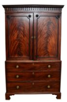 A George III flame mahogany linen press, circa 1780s, the pierced cornice over a pair of beaded