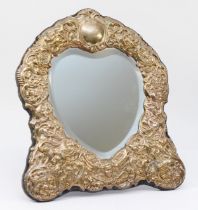 A silver heart shaped bevelled easel mirror, Sheffield 1996, with embossed floral, bird and cherub