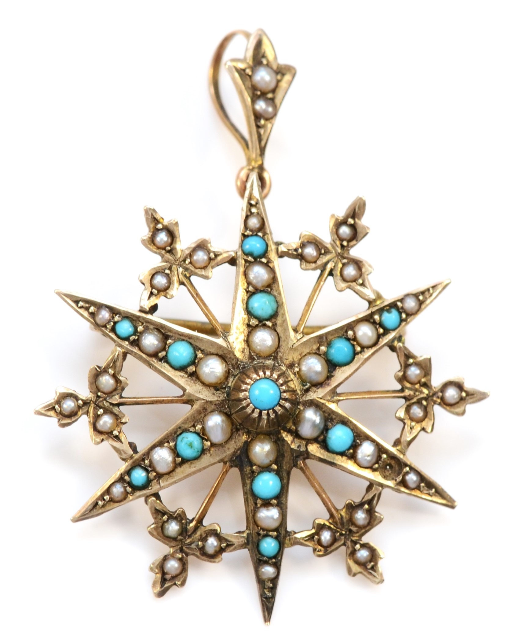 A 9ct gold turquoise and half pearl six ray star brooch/pendant, Birmingham 1915, one turquoise