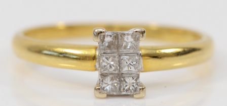 An 18ct gold and Princess cut diamond panel ring, claw set with six stones, stated weight 0.20cts,