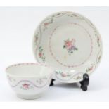 A 19th century Newhall tea bowl & saucer, having floral garland and sprig decoration. (2)