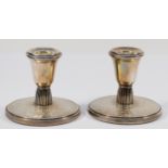 A silver pair of desk candlestick's, Birmingham 1961, with engine turned and engraved floral