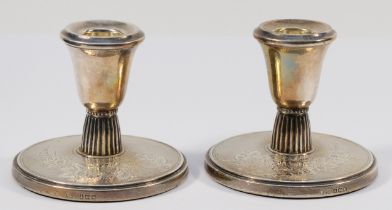 A silver pair of desk candlestick's, Birmingham 1961, with engine turned and engraved floral