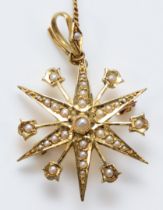 A Victorian 15ct gold and half pearl eight ray star brooch/pendant, detachable bail, 29mm, 4.5gm