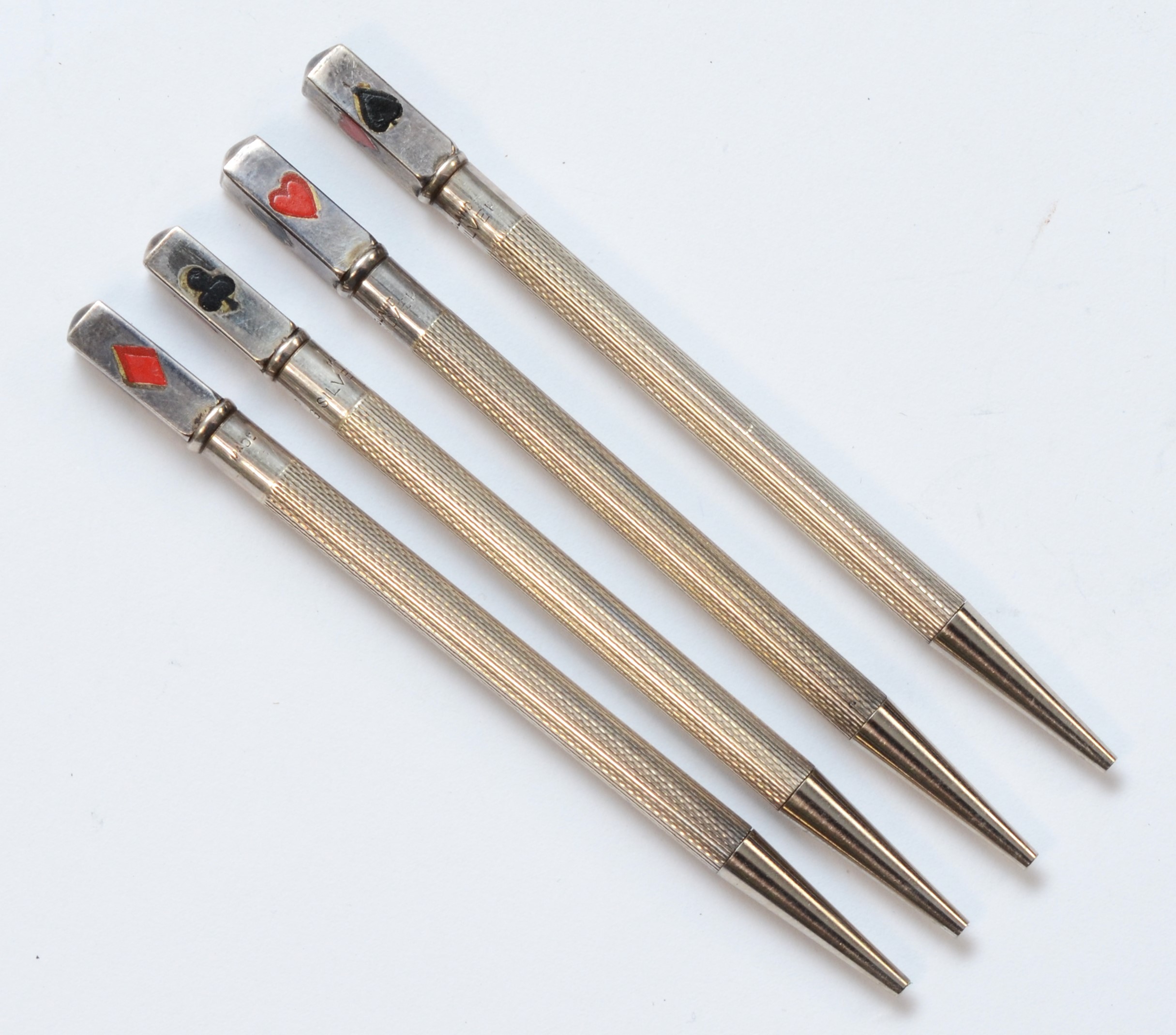 A Sterling Silver and enamel set of four playing card propelling pencils, 9cm, 24gm