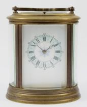 An early 20th century brass case carriage clock, of oval form with painted dial and Roman