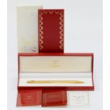 Cartier, de Must, a gold plated Stylos ball point pen, c.1992, with booklets, case and box. Very