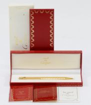 Cartier, de Must, a gold plated Stylos ball point pen, c.1992, with booklets, case and box. Very