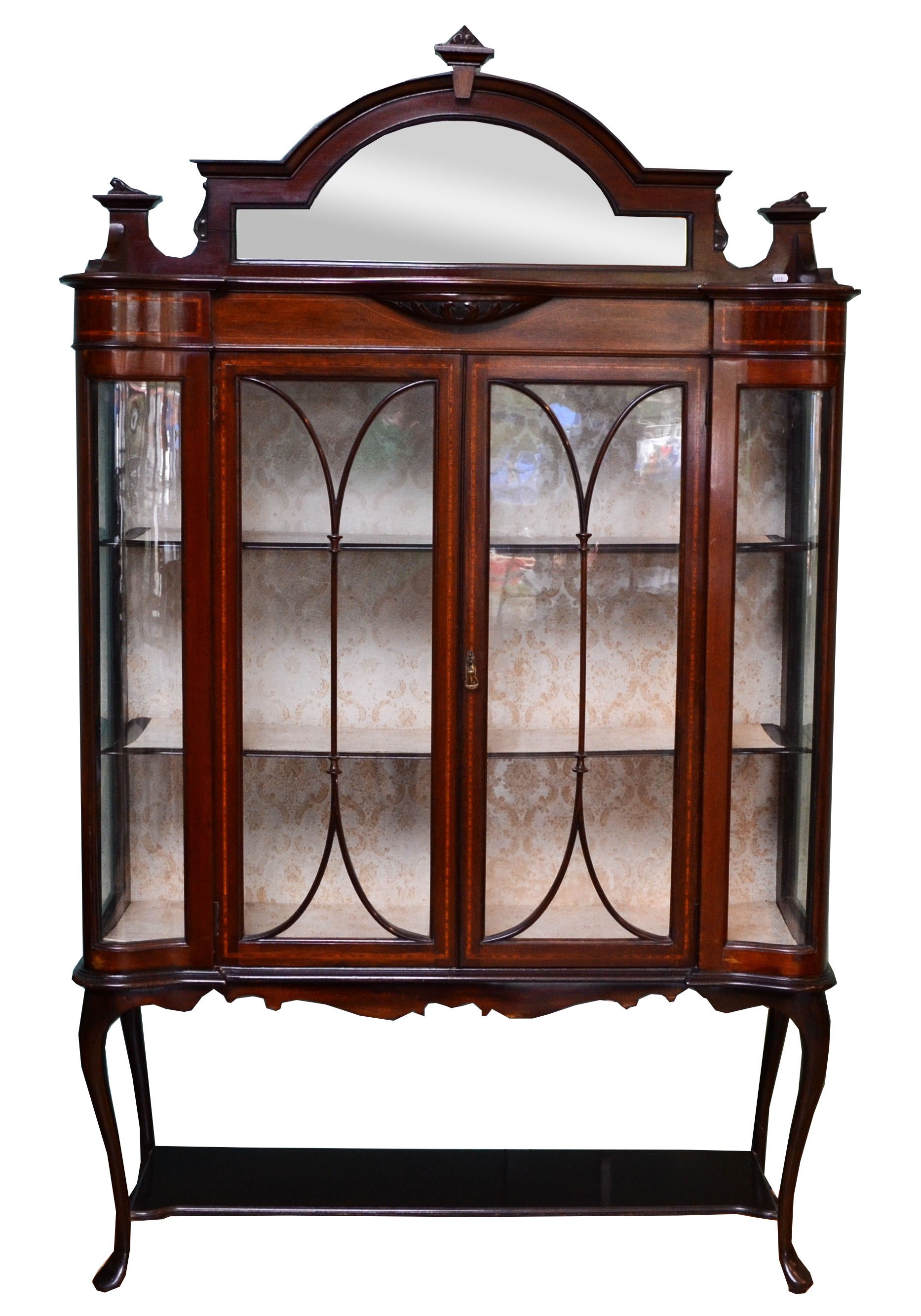 Edwardian inlaid mahogany display cabinet, the central arched mirror plate within a carved scroll