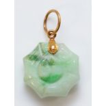 A Chinese gold mounted jadeite Jin/Jan pendant, bordered by a spiders web, diameter 15mm