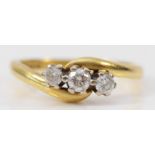 An 18ct gold and brilliant cut diamond crossover three stone ring, stated weight 0.33cts, L, 3.5gm