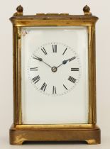 A 20th century brass carriage clock, the enamelled dial with Roman and Arabic numerals, having an