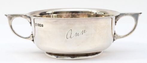 A silver two handled porringer, Sheffield 1915, engraved Ann, 17.5cm across the handles, 255gm