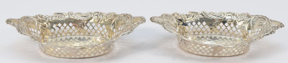 A Victorian silver pair of bon bon dishes, by Nathan & Haynes, Chester 1899, of oval pierced form,