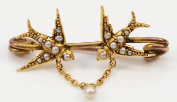 A Victorian unmarked gold and half pearl love bird brooch, single pearl drop below, tests as 15ct