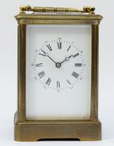 An early 20th century brass case carriage clock, the enamelled dial with Roman and Arabic