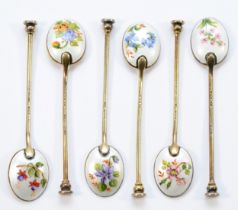 A silver gilt and enamel set of six coffee spoons, Birmingham 1957, the bowls decorated with