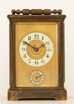 An early 20th century brass carriage clock, porcelain dial with Arabic numerals, subsidiary alarm