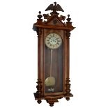 An early 20th century Vienna style wall clock, mahogany and walnut veneered case with carved