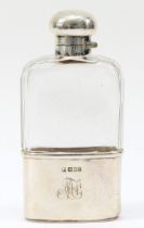 A silver and glass hip flask, by Mappin & Webb, London 1910, with bayonet cap and pull off base,