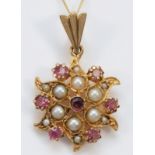 An unmarked Victorian style rose gold pink tourmaline and half pearl pendant, diameter19mm, chain,