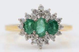 A vintage 18ct gold emerald and diamond cluster ring, claw set with three graduated mixed cut stones