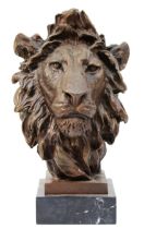 A large bronze sculptured mask of a lion, signed 'Barye', upon a square polished marble plinth, 31cm