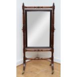A Victorian mahogany cheval mirror, pierced and carved shell pediment with extending scrolling