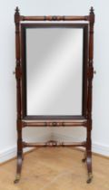 A Victorian mahogany cheval mirror, pierced and carved shell pediment with extending scrolling