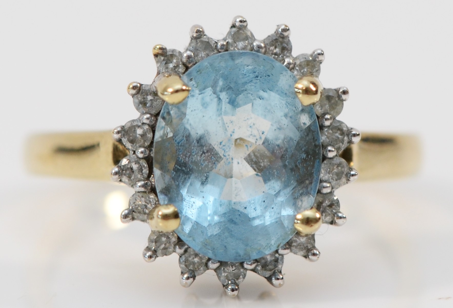 A 9ct gold aquamarine and brilliant cut diamond cluster ring, stone 10 x 8mm, O, 3.2gm