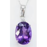 A 9ct white gold amethyst pendant, claw set with a mixed cut stone of good colour, 14 x 10mm,