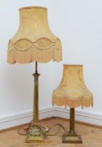 A tall gilt brass table lamp, in the form of Corinthian column on a stepped base, with tassel fabric