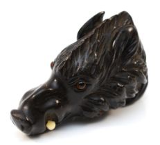 A 19th century carved horn cane handle, in the form of a wild boar, with glass eyseand bone tusks,