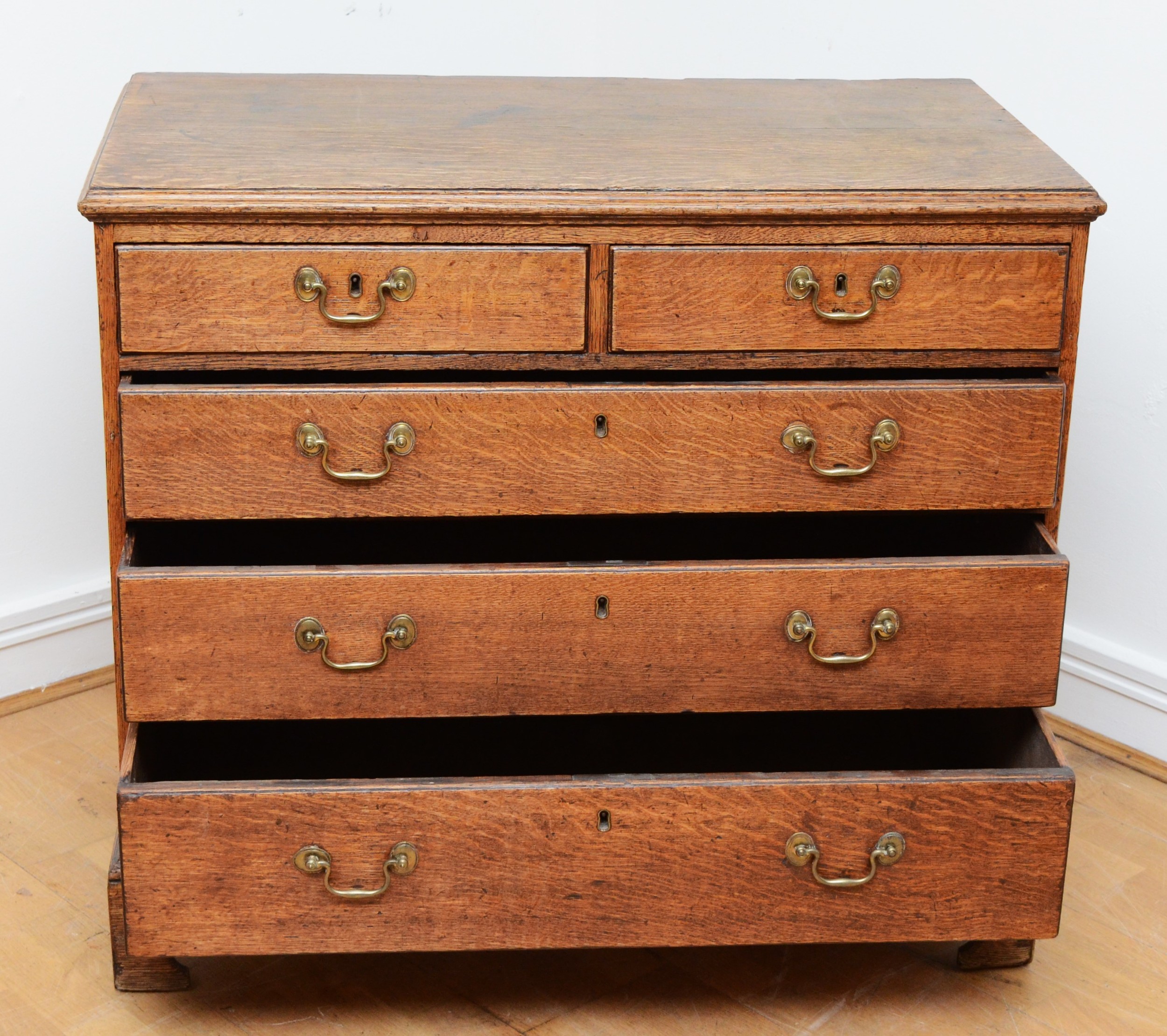 A late 18th century Georgian oak chest, the moulded edged top over two short and three long - Image 2 of 4