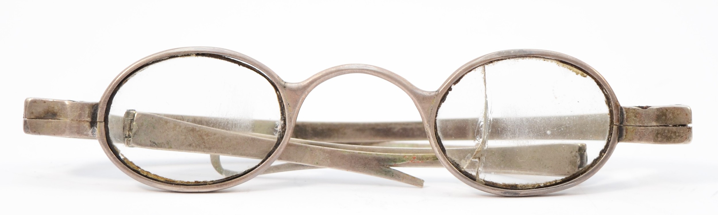 A George III silver pair of spectacles, by TD, London 1809, of plain folding form.
