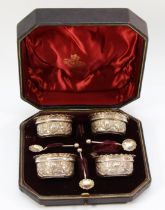 A Victorian silver set of four open salts, Birmingham 18993, with embossed decoration, three