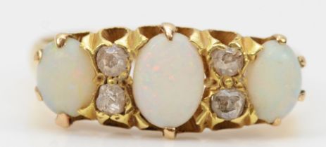 An Edwardian 18ct gold three stone opal ring, old cut diamonds between, London 1915, S, 4gm