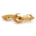A Victorian 9ct gold red paste and half pearl crescent and scroll brooch, Chester 1898, 45mm,