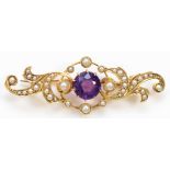 An unmarked Victorian gold amethyst and half pearl scroll brooch, tests 9ct, 41mm, 4.1gm