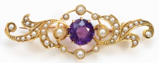 An unmarked Victorian gold amethyst and half pearl scroll brooch, tests 9ct, 41mm, 4.1gm