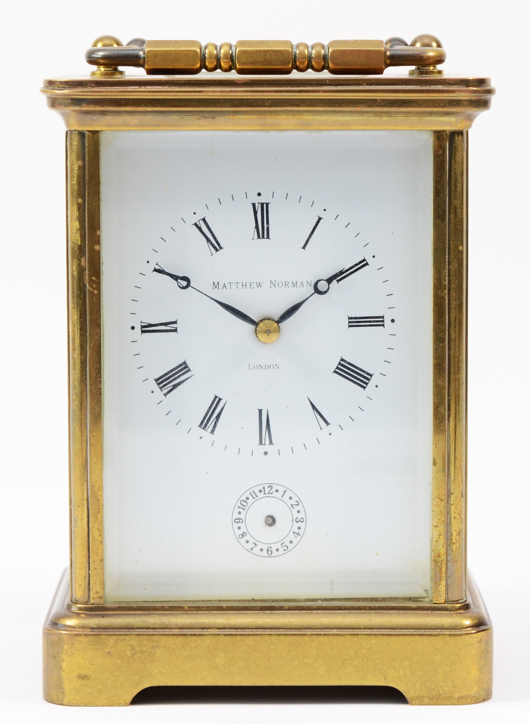 A 20th century Matthew Norman brass case carriage clock, having enamelled white dial with Roman